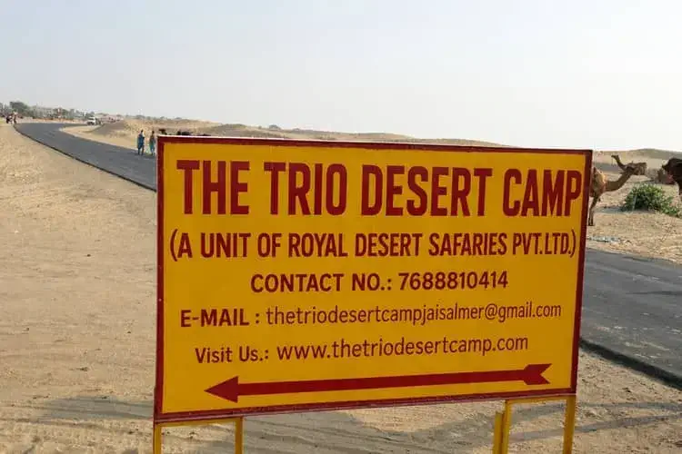 the trio desert camp sign board
